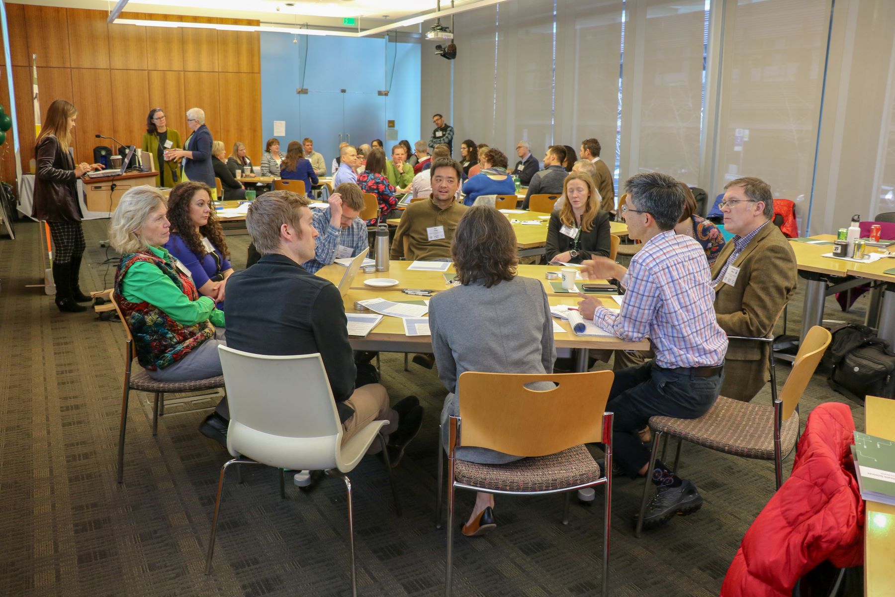 Group of people sit around a table.