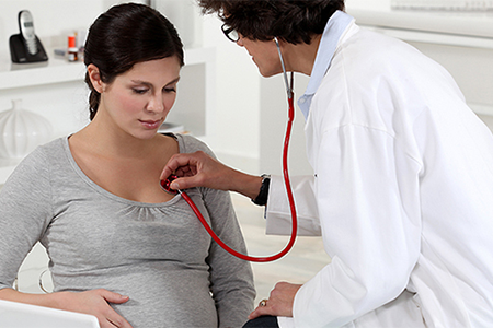 Image of pregnant woman and physician.